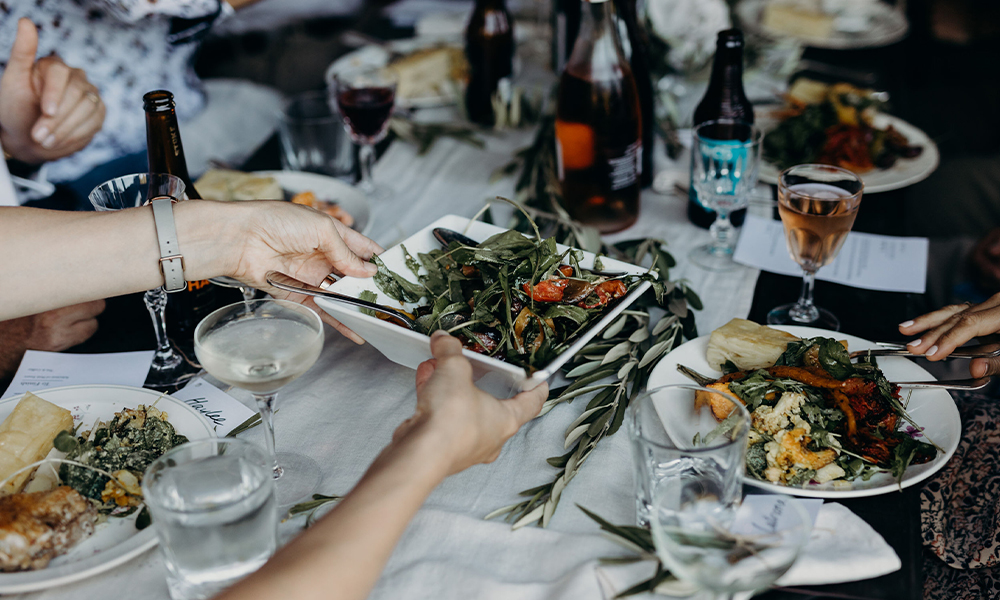 Guests share a beautiful salad at a wedding dinner